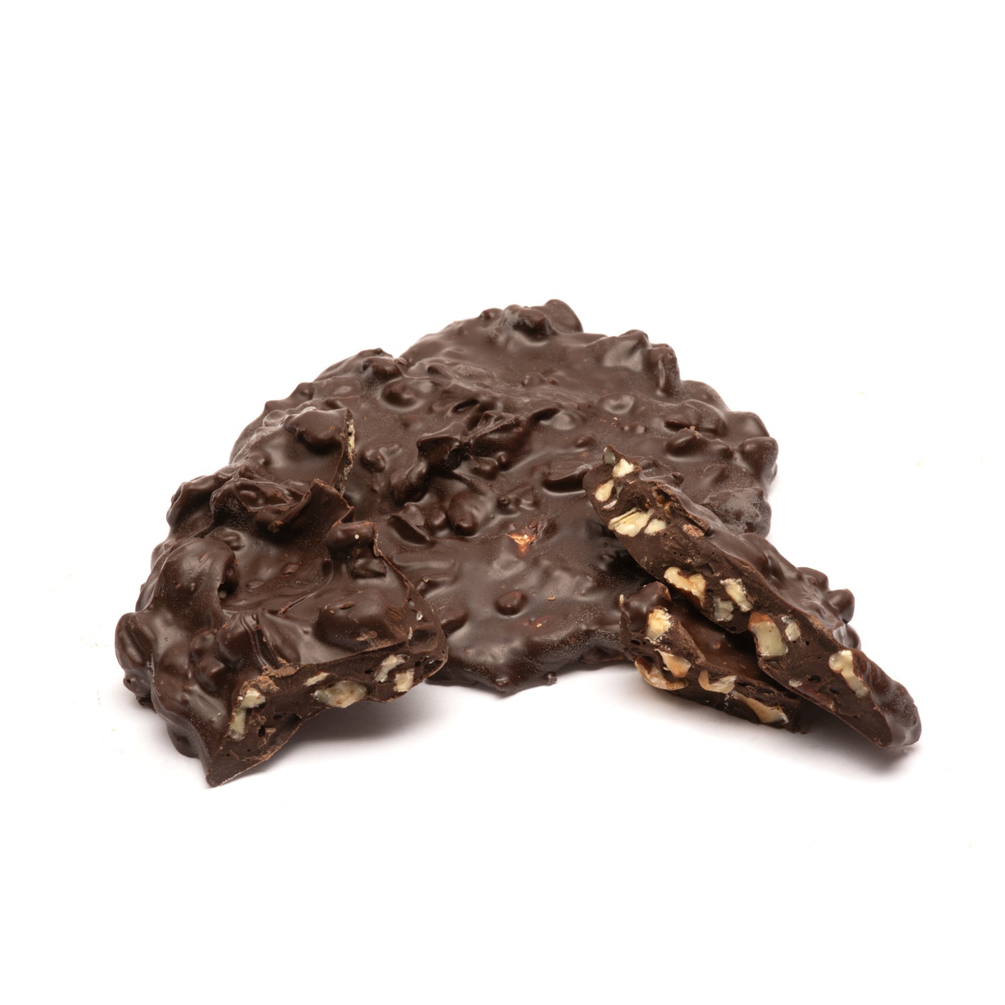 Dark chocolate nut cluster with a textured surface on a white background