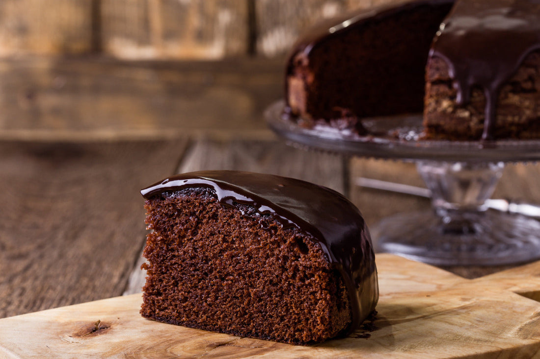 Slice of chocolate cake with shiny chocolate glaze