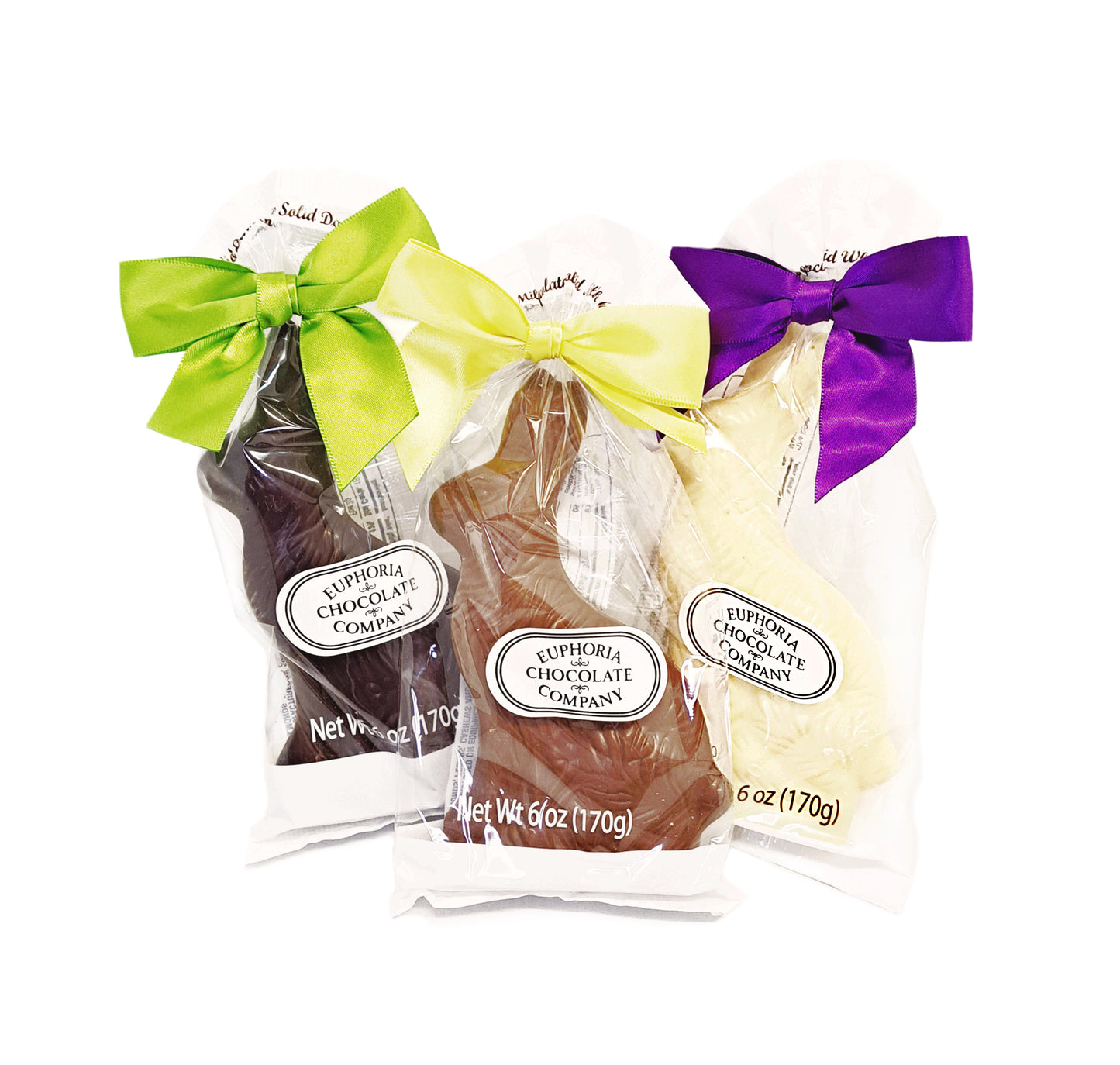 Three chocolate bars in clear packaging with colorful bows on a white background