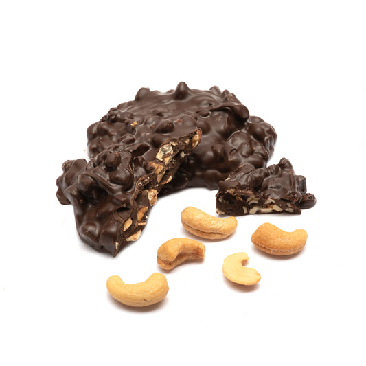 Dark chocolate-covered cashew chortles on a white background