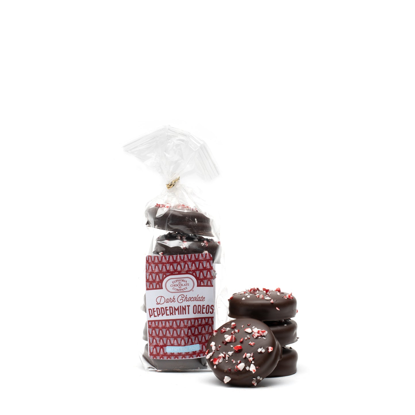 A packaged of dark chocolate covered cream stuffed wafer cookies with peppermint sprinkles, alongside several cookies placed outside the packaging against a white background.