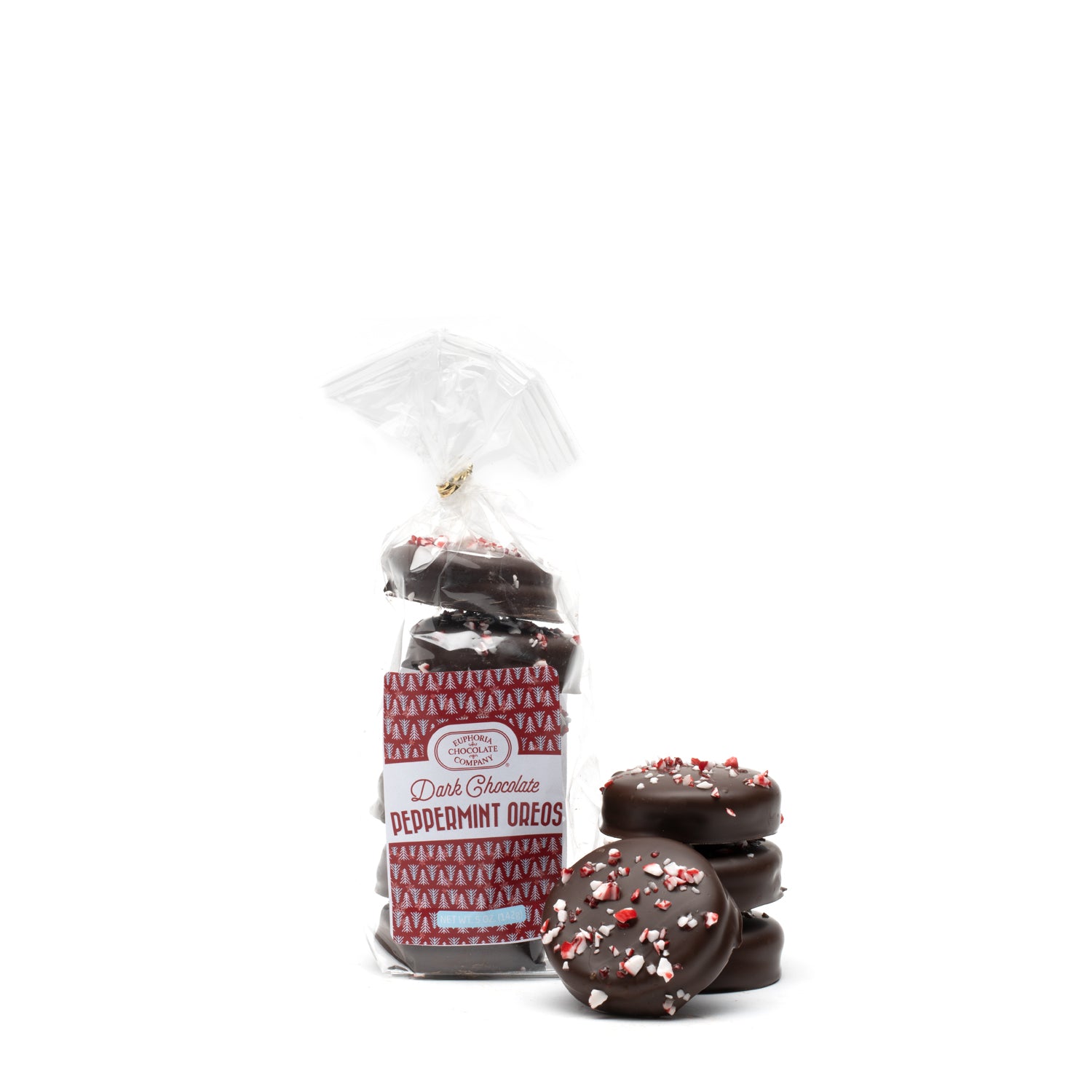 A packaged of dark chocolate covered cream stuffed wafer cookies with peppermint sprinkles, alongside several cookies placed outside the packaging against a white background.