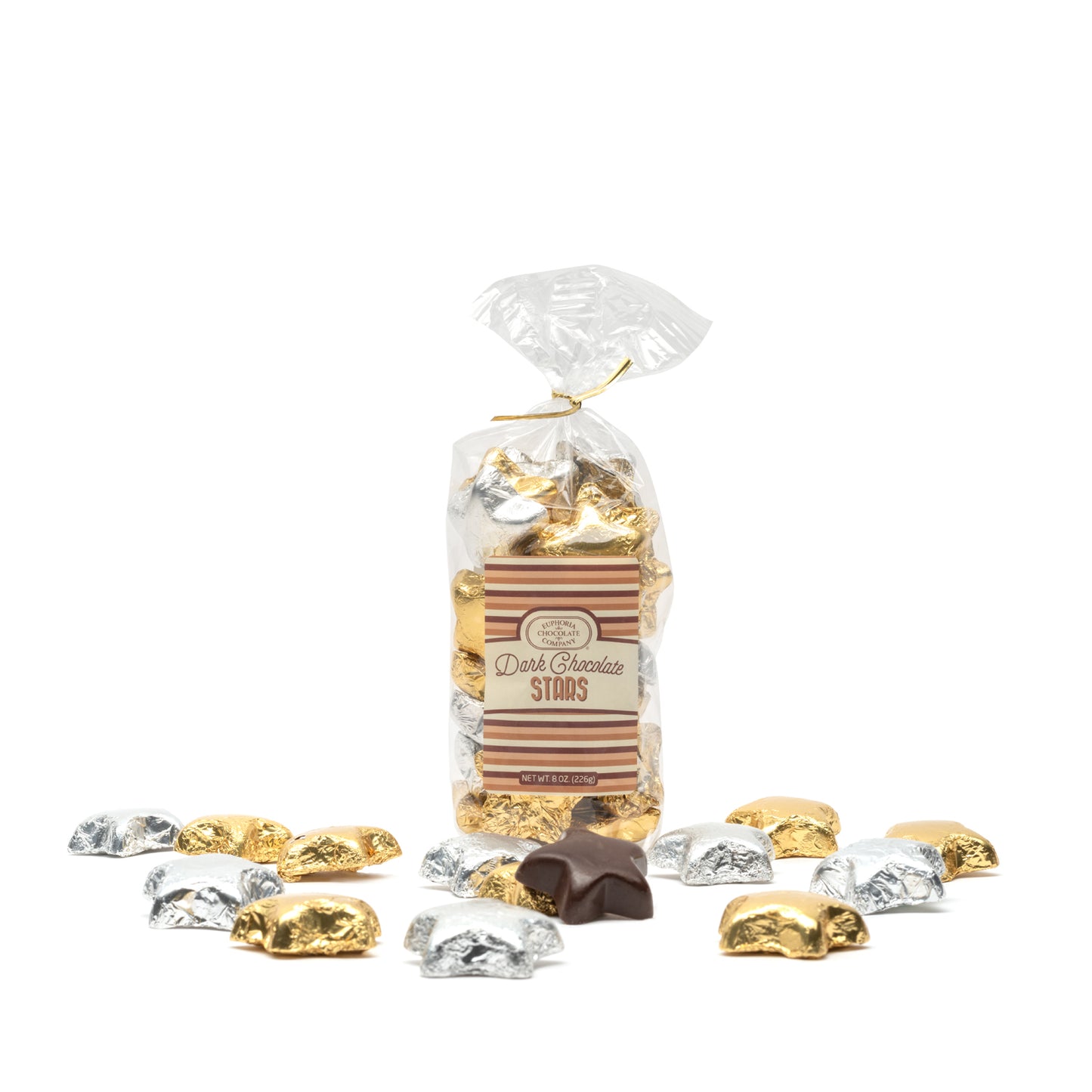 Bag of dark chocolate stars with gold, silver, and brown foil wrappings on a white background