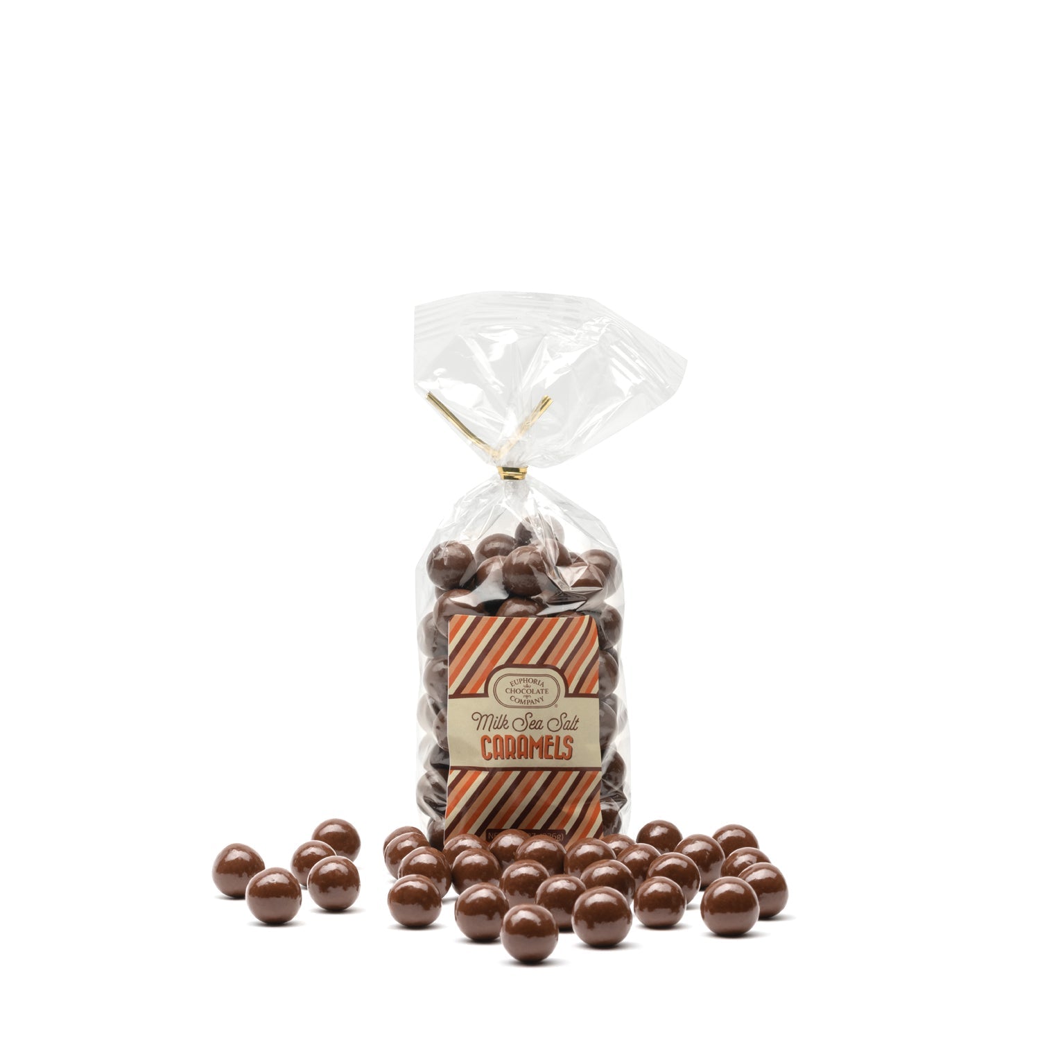 A clear plastic bag filled with milk chocolate covered caramel candies with sea salt, displayed with loose caramel candies scattered in front and labelled with the Euphoria Chocolate Company logo against a white background.