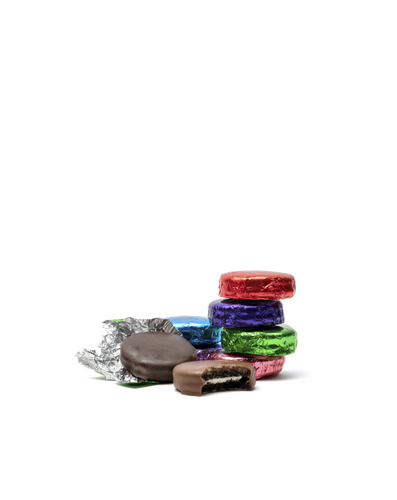 Assorted chocolate-covered creme filled sandwich cookies with colorful foil wrappers on a white background