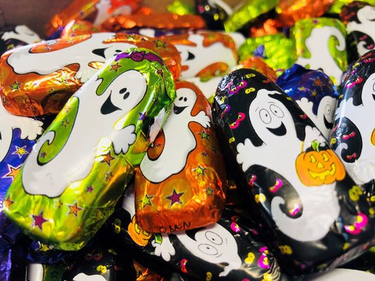Halloween-themed candy treats with ghost designs on colorful foil wrappers.