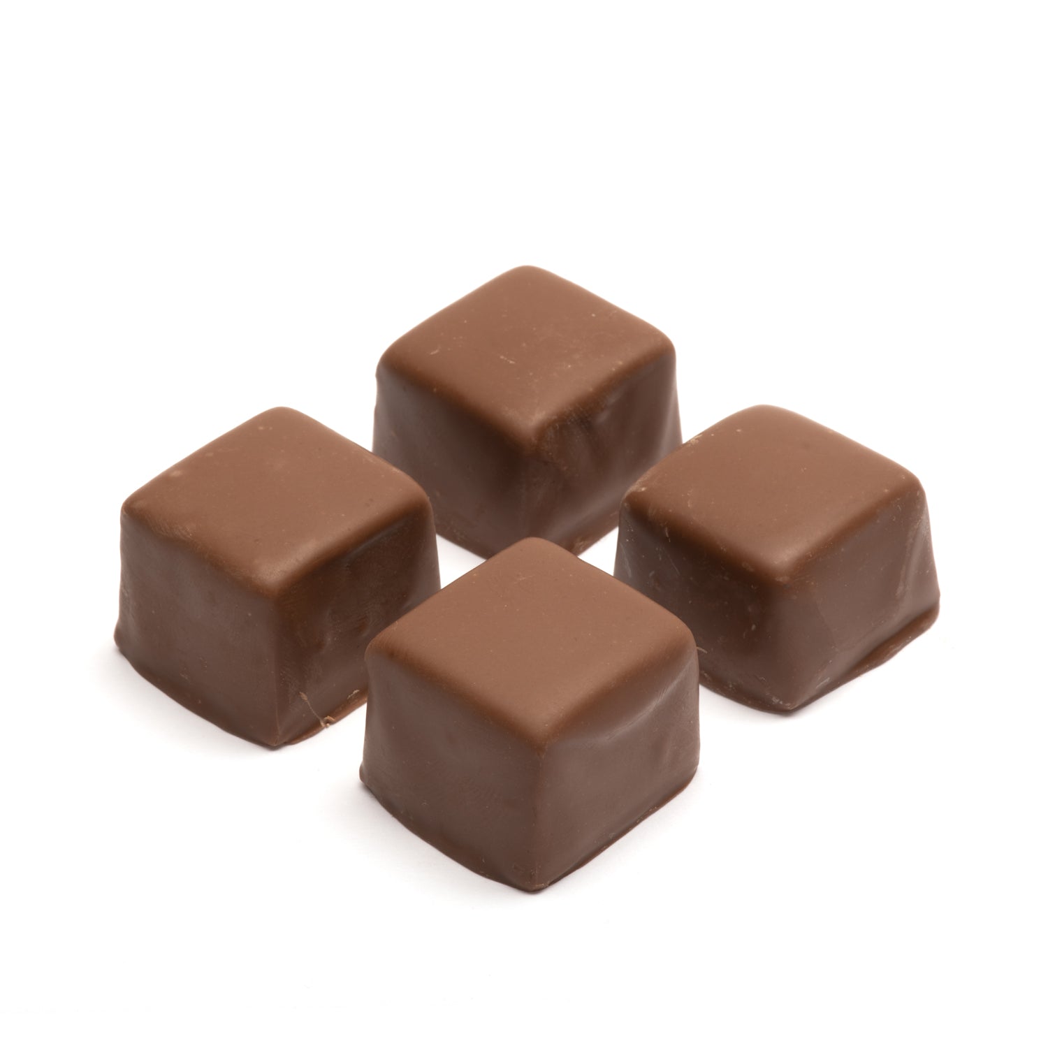 Four milk chocolate caramel squares on a white background