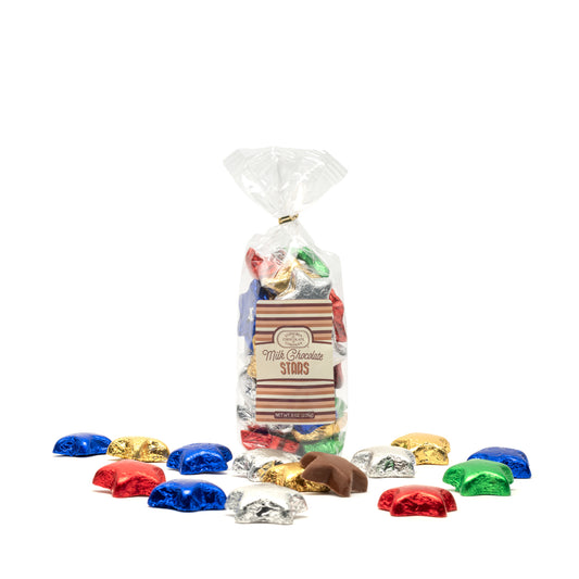 Bag of milk chocolate stars with colorful foil wrappers on a white background