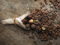 Chocolate truffles spilling out with coffee beans and sugar