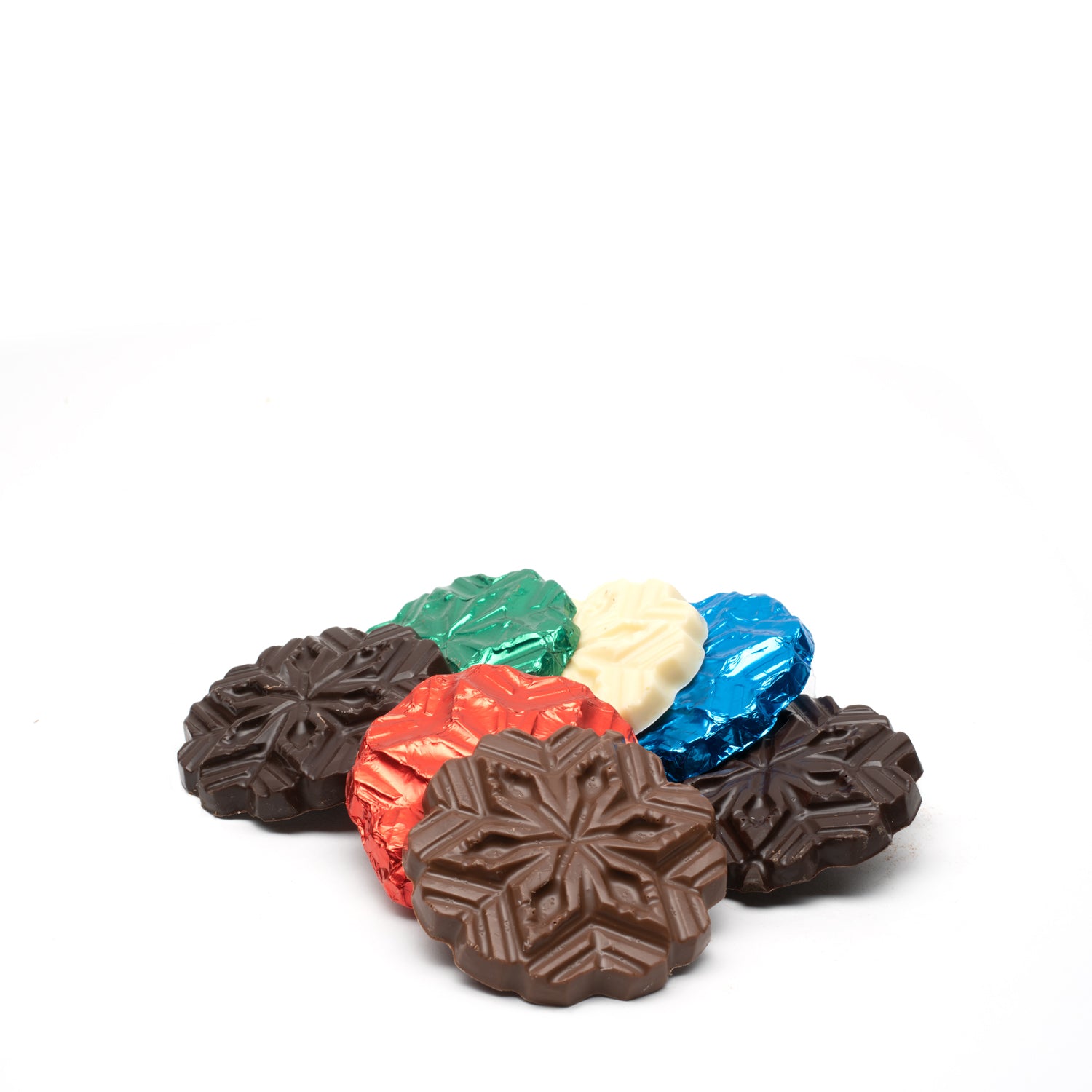 Colorful foil-wrapped chocolate snowflakes on a white background
