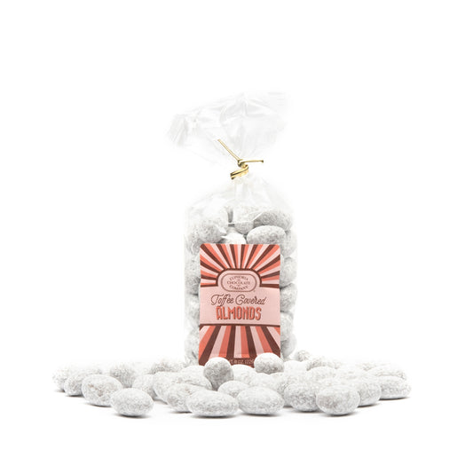 A clear plastic bag filled with toffee covered almonds, sealed with a gold tie and labeled with a red and white Euphoria Chocolate Company label.