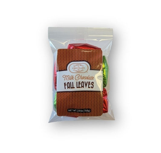 A package of Euphoria Chocolate Company's Milk Chocolate Fall Leaves, featuring a clear bag containing chocolate pieces wrapped in red and green foil, with a brown knit-patterned label in the center.