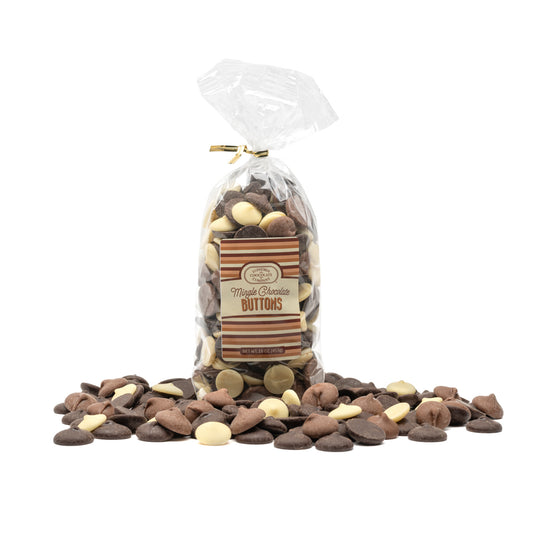A clear plastic gift bag filled with an assortment of chocolate buttons, including white, milk, and dark chocolate varieties, with a gold ribbon and label displaying the Euphoria Chocolate Company brand and product name.