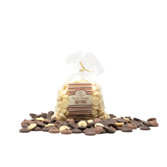 A clear gift bag filled with creamy white chocolate buttons with a Euphoria Chocolate Company label, presented on a white background.