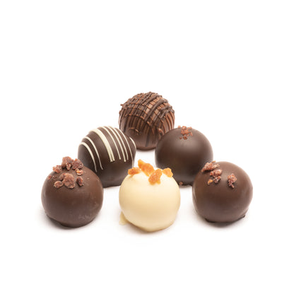 An assortment of 6 Euphoria Chocolate Company truffles in milk, dark, and white chocolate against a white background.