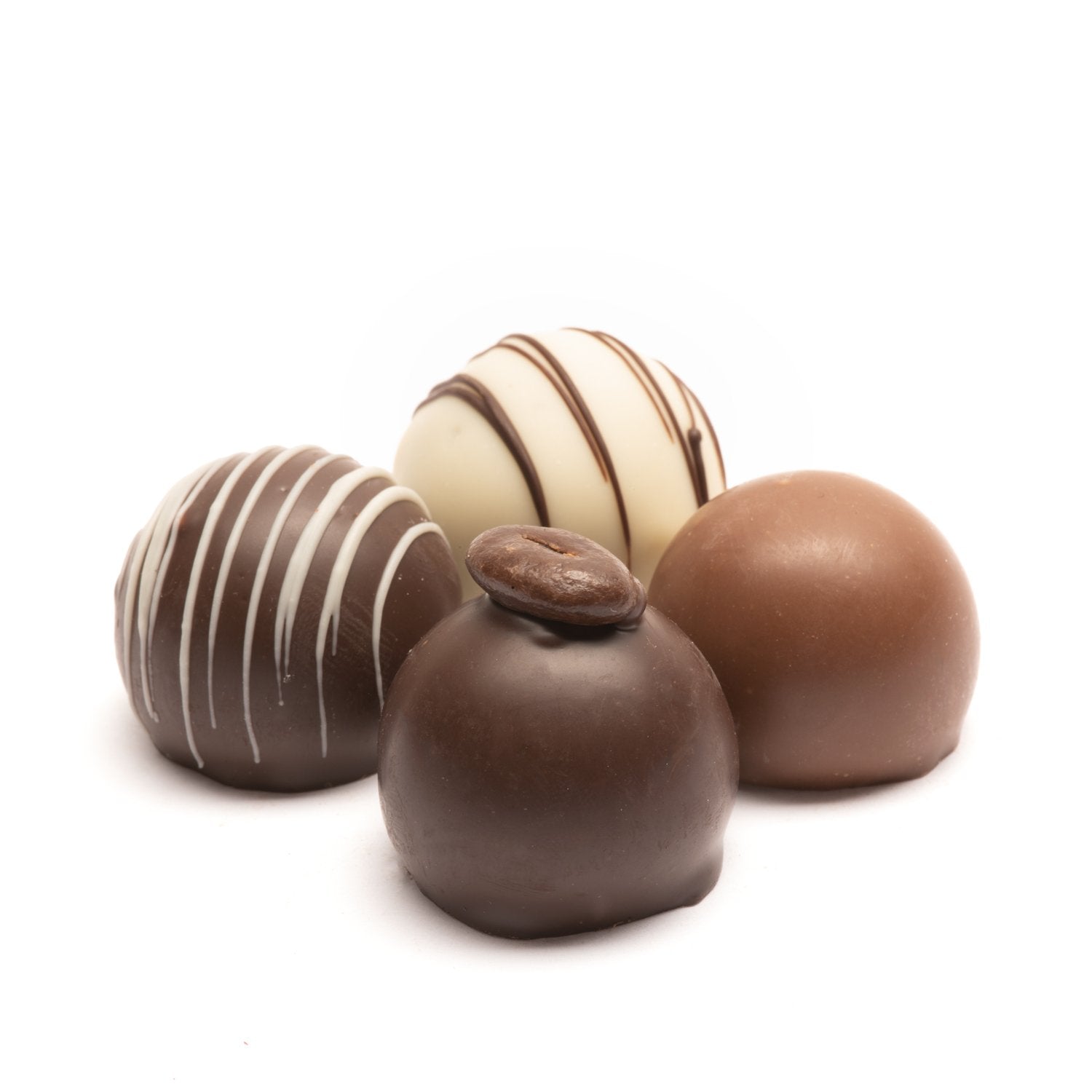 Four chocolate Euphoria Chocolate Company truffles in milk, dark, and white chocolate against a white background.