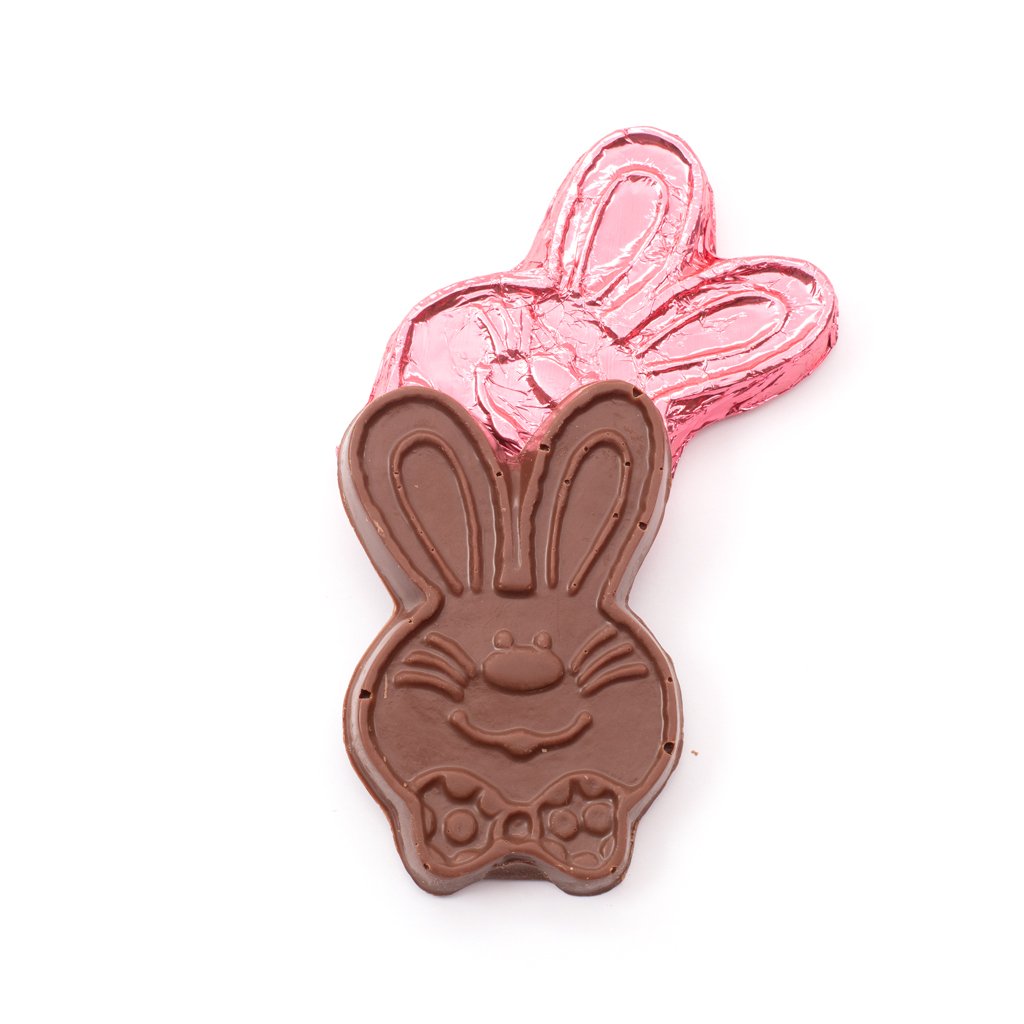 A smiling milk chocolate cartoon rabbit face in front of the same product wrapped in pink foil against a white background.