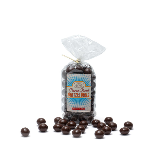 A clear plastic packaging containing dark chocolate covered pretzel balls with a Euphoria Chocolate Company label reading 'Peanut Butter Pretzel Balls' against a white background.